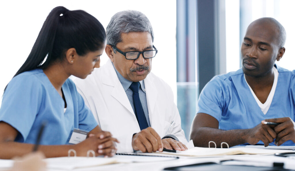 medical practitioners having a meeting in a hospital boardroom
